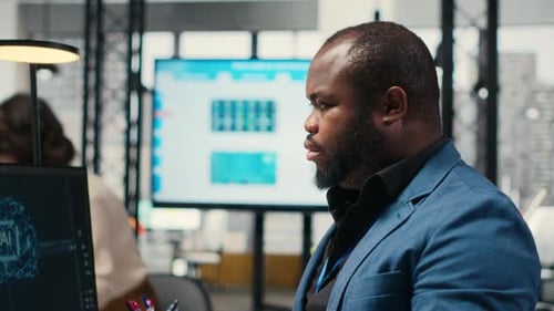 Man Working on AI Project in Modern Office