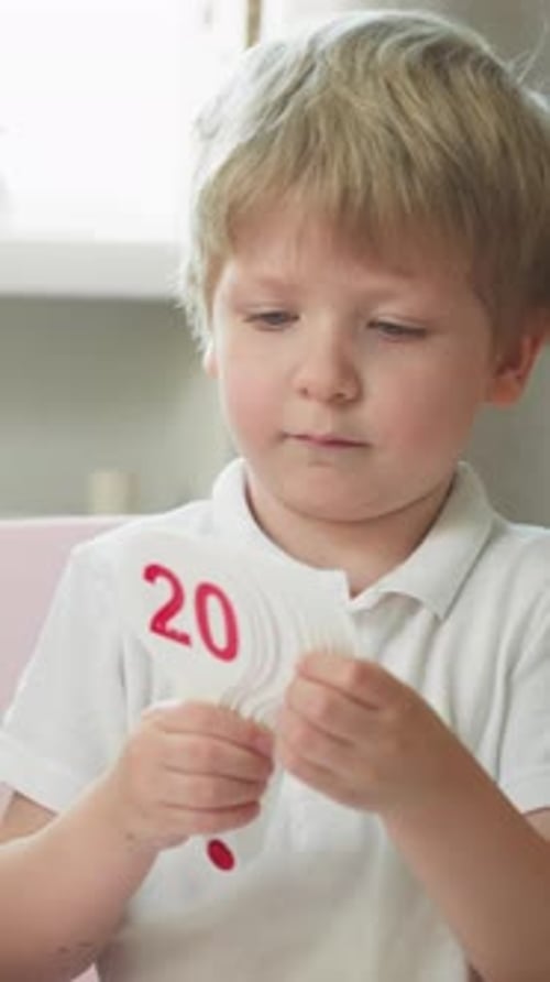 Cute Little Boy Learns Cards with Digits and Fans at Preschool