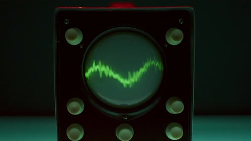 Retro-Style Oscilloscope Showing Green Sine Wave on Screen in Neon-Lit Studio