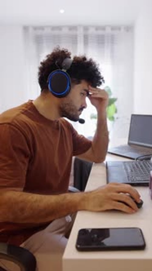 Boy in Front of Computer Thoughtfully Stands Up and Smiles