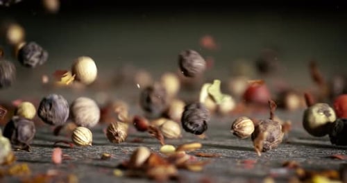 Mixed peppercorns in a super slow motion. Dry mix peppercorns close up.