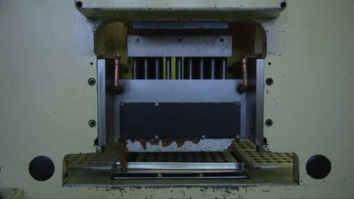 molds are filled with chocolate in a chocolate factory