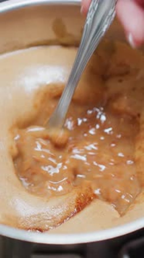 Stirring Brown Sugar Mixture in Pot on Stove