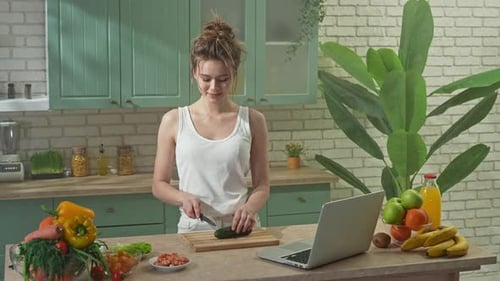 Young Woman at the Table in the Kitchen Preparing Spring Rolls for Healthy Lunch Woman Cutting