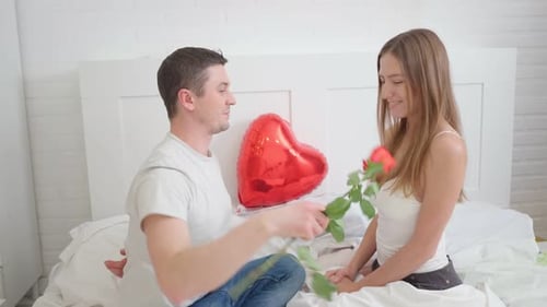 Romantic Couple Celebrating with Rose and Heart Balloon