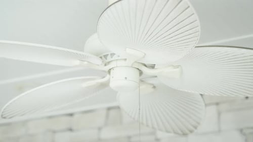 White modern design retro ceiling fan slowly rotating