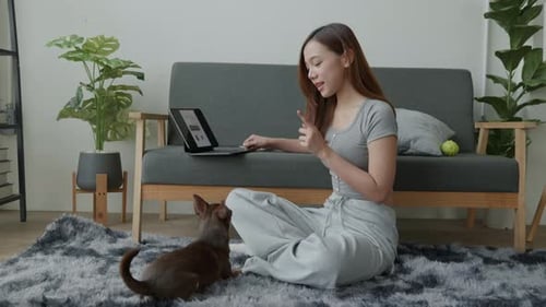 Woman Using Tablet with Dog in Living Room