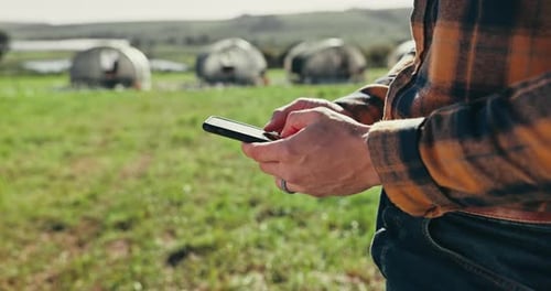 Farmer Using Cell Phone in Rural Field