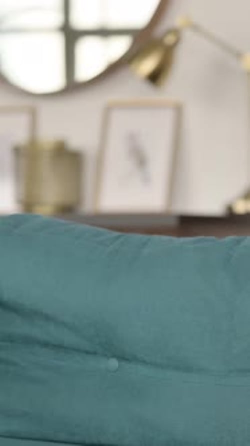 Man Sitting on Couch Relaxing Indoors at Home