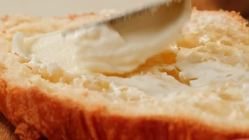 Buttering Bread Slice with Knife Close-Up
