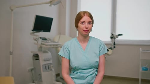 doctor gynecologist sits in the gynecological office near the ultrasound and gynecological chair