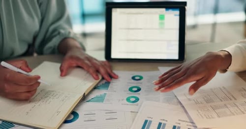 Business Reviewing Financial Data at Table