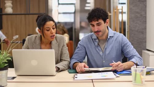 Professional Business Colleagues Collaborating on Laptop in Office