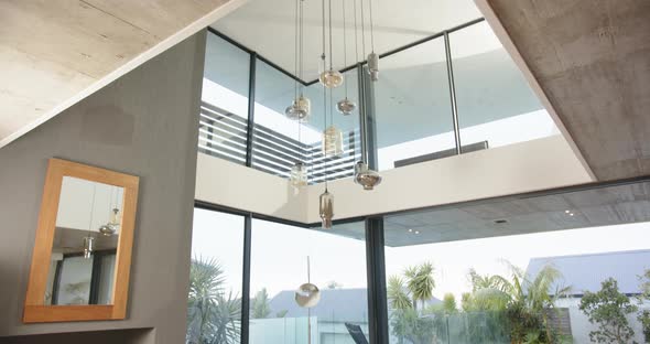 Modern living room with large windows overlooking pool and outdoor ...