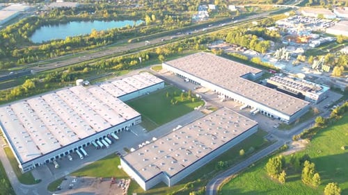 Aerial view of goods warehouse. Logistics center in industrial city zone from above. Aerial view of