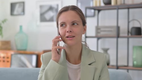 Young Businesswoman Talking on phone in Creative Office