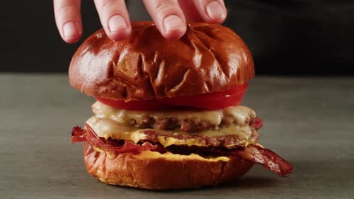American Fat Smash Burger with Fresh Tomatoes and Cheese on Grill Closeup Macro Beef or Pork Cutlet