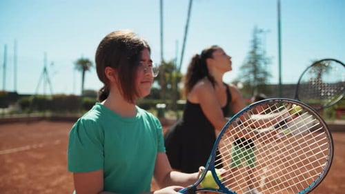 Young Tennis Players Practicing on Clay Court