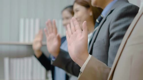 Group of business people waving a hand in greeting in hello gesture welcomes someone