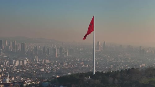 City Skyline with Large Red Flag Waving