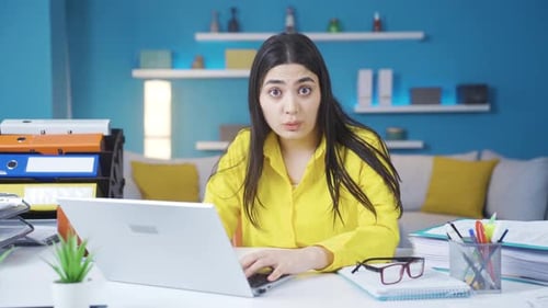 Young Adult Woman Looks Shocked at Laptop