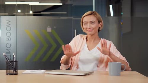 Business Woman Closes Laptop Dances with Joy in the Office Listening to Music