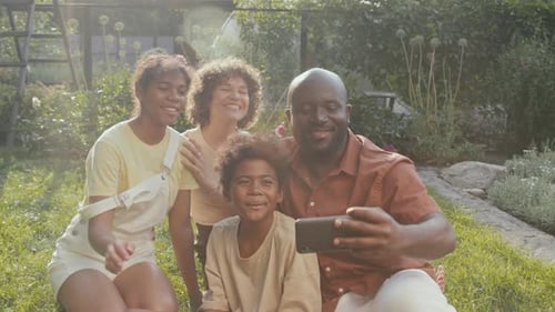 Happy Family Takes Selfie in Backyard Garden