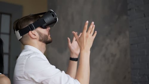 Couple wearing VR headsets interacting with virtual reality