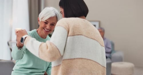 Senior Woman Dancing with Friend in Living Room