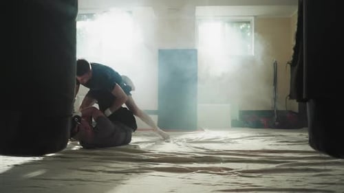 Sportsman Beats Partner Lying on Floor in Club