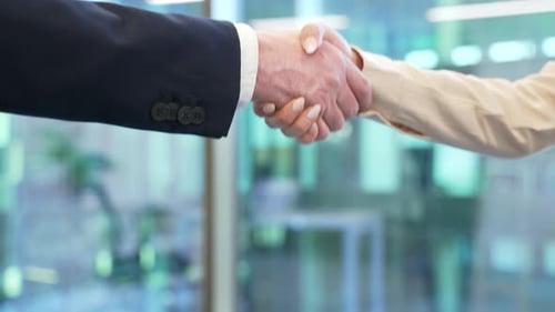 Close up of business handshake symbolizing teamwork and cooperation. Two professionals, a man