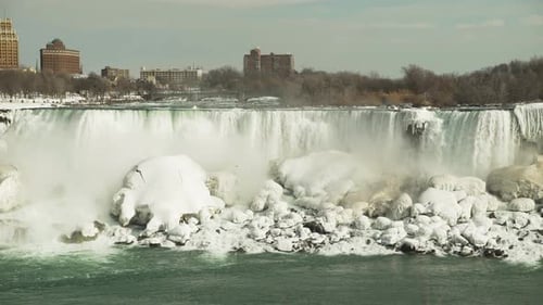 Beautiful static view of Niagara Falls over icy rocks in wintertime