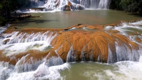 Cinematic revealing drone shot of the Cascadas de Agua Azul and the waterfalls found on the Xanil Ri