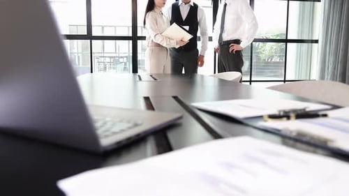 Business Team Meeting to Review Documents in Office