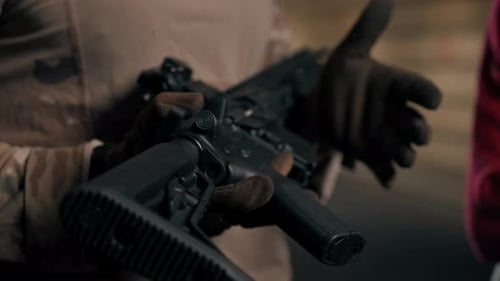 Close Up At a Professional Shooting Range Military Trainer Tells a Girl How to Properly Handle NATO