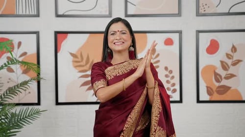 Smiling Woman in Sari Clapping Hands Indoors