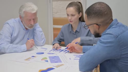 Colleagues Analyzing Data in a Workplace