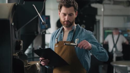 Man inspects Coffee Beans from Roasting Machine