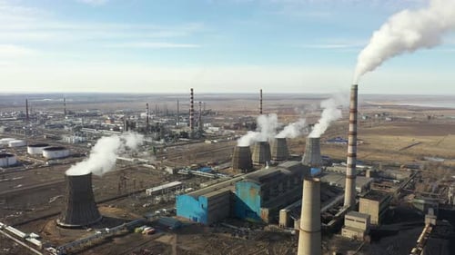 Aerial View of Thermal Power Plant Drone Flies Over Chimney Smoke Pipes and Cooling Towers of