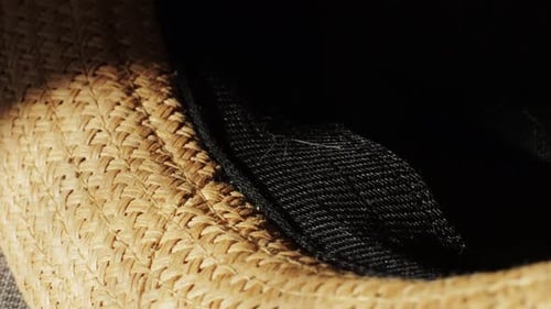 Close Up of Brown Woven Hat with Black Band