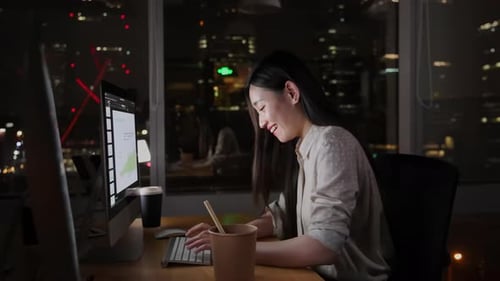 Successful Businesswomen Sitting in Creative Agency, Working on Laptop Computer celebrating successf