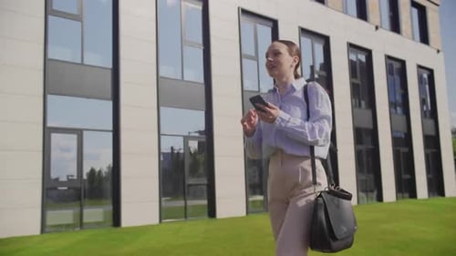 Business Woman Using Mobile Phone Going to Work