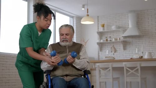 Man in Wheelchair Exercises with Assistance