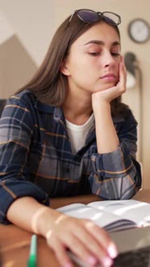Student Girl Boring During Online Lecture Sitting Alone in Room Looking at Laptop Screen Portrait