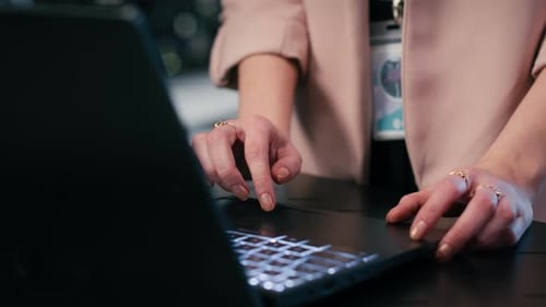 Typing Laptop Close Up and Engineer in Server Farm