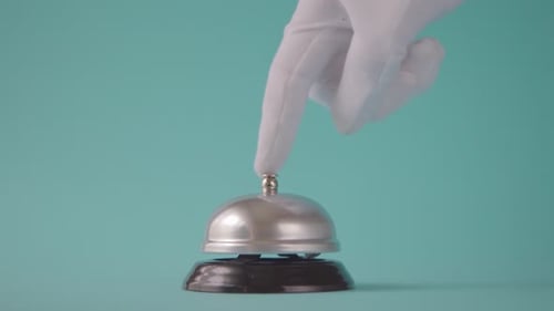 Hand Rings Reception Bell on Blue Background