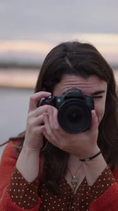 Closeup of a Female Photographer Pointing Her Camera at the Subject