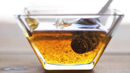 Healthy Food, Eating, Natural Cosmetics and Objects Concept - Honey in Glass