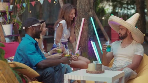 Friends Enjoying Drinks and Conversation at Outdoor Gathering