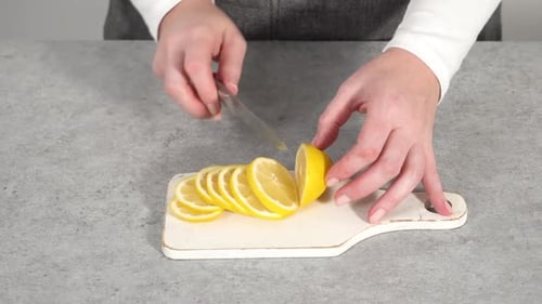 Step By Step Slicing Organic Lemon Wedges on a White Plate